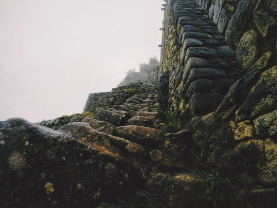 Stairs climbing down Huayna Picchu in Peru, smothered in fog