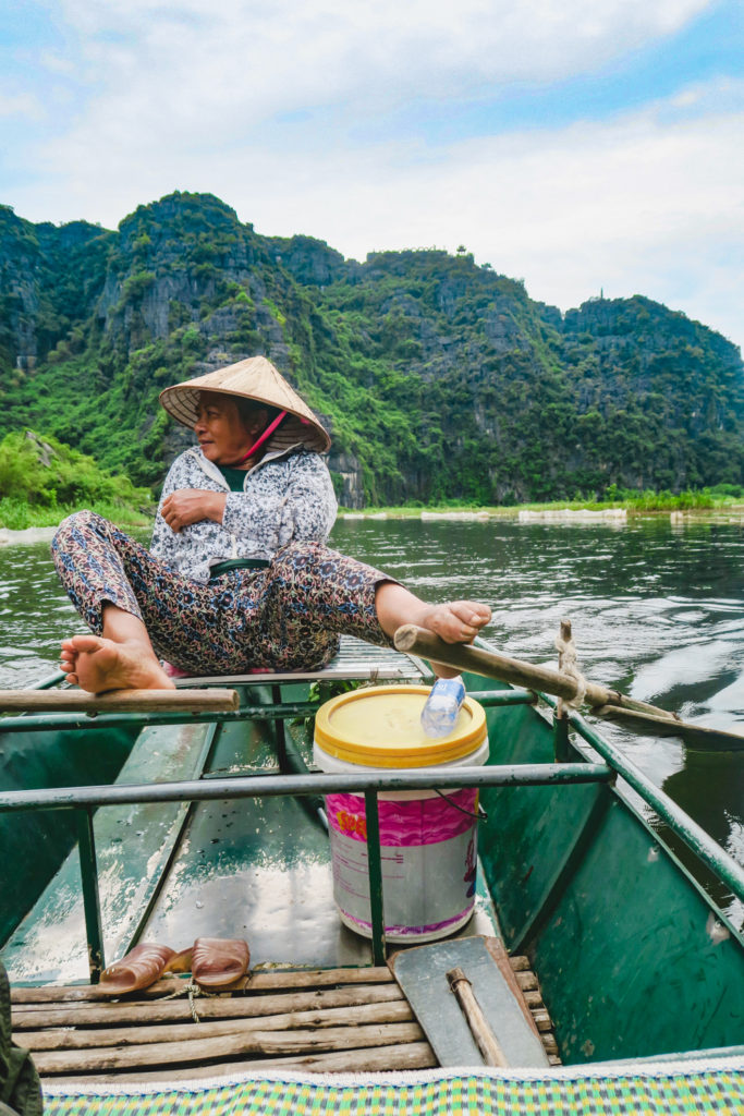 On the Tam Coc boat tour, the rowers are rowing with feet