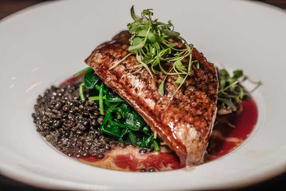 Hilton Anaheim restaurant fish: it was striped bass with beluga lentils, spinach, and cabernet beurre rouge.